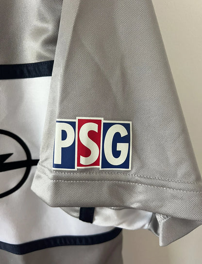 Maillot de foot vintage extérieur gris du PSG de la saison 2000/2001. On peut retrouver l'équipementier Nike et le sponsor Opel. Il s'agit d'un maillot authentique d'époque.