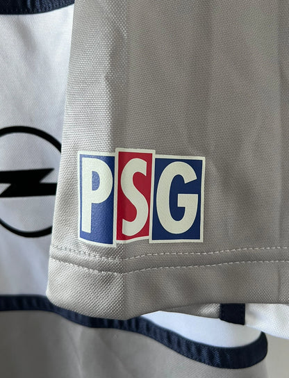 Maillot de foot vintage extérieur gris du PSG de la saison 2000/2001. On peut retrouver l'équipementier Nike et le sponsor Opel. Il s'agit d'un maillot authentique d'époque.