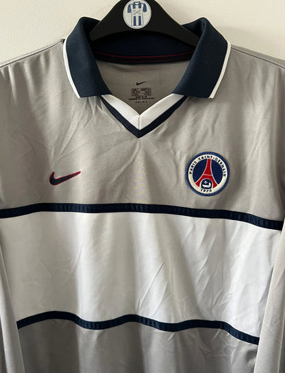 Maillot de foot vintage extérieur gris et blanc du PSG saison 2000/2001. On peut retrouver l'équipementier Nike. Il s'agit d'un maillot authentique d'époque issu du stock pro.