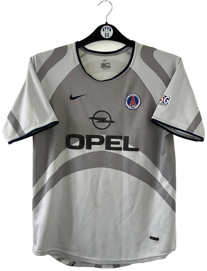 Maillot de foot vintage extérieur gris du PSG de la saison 2001/2002. On peut retrouver l'équipementier Nike et le sponsor Opel. Il s'agit d'un maillot authentique d'époque