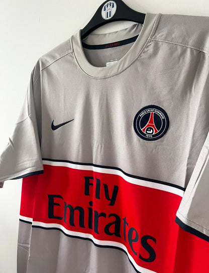 Maillot de foot vintage extérieur gris du PSG de la saison 2008/2009. On peut retrouver l'équipementier Nike et le sponsor Fly Emirates. Il s'agit d'un maillot authentique d'époque.