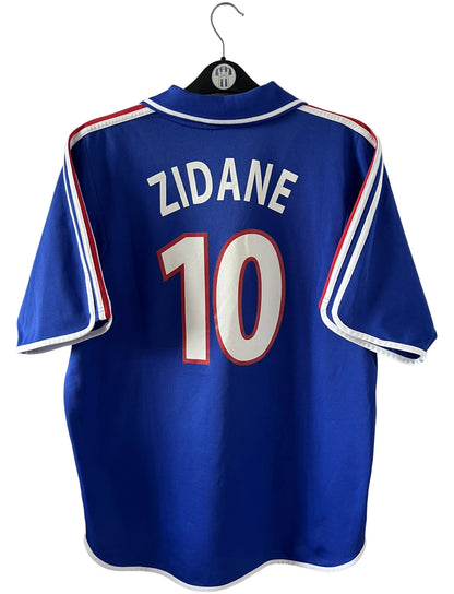 Maillot de foot vintage domicile bleu de l'Equipe de France 2000. On peut retrouver l'équipementier Adidas. Le maillot est floqué du numéro 10 Zinedine Zidane. Il s'agit d'un maillot authentique d'époque comportant la mention France-Italie 02-07-2000.