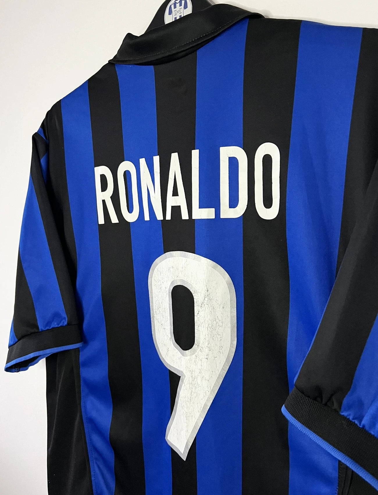Maillot de foot vintage domicile bleu et noir de l'Inter Milan de la saison 1998/1999. On peut retrouver l'équipementier Nike et le sponsor Pirelli. Le maillot est floqué du numéro 9 Ronaldo. Il s'agit d'un maillot authentique d'époque.