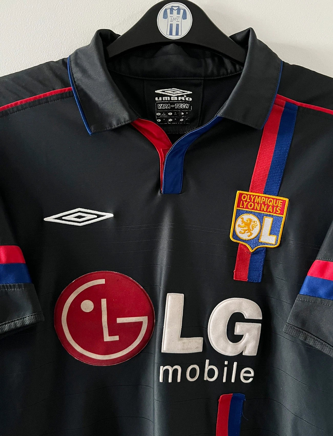 Maillot foot vintage extérieur noir de l'OL 2004/2005. On peut retrouver l'équipementier Umbro et le sponsor LG. Il s'agit d'un maillot authentique d'époque.