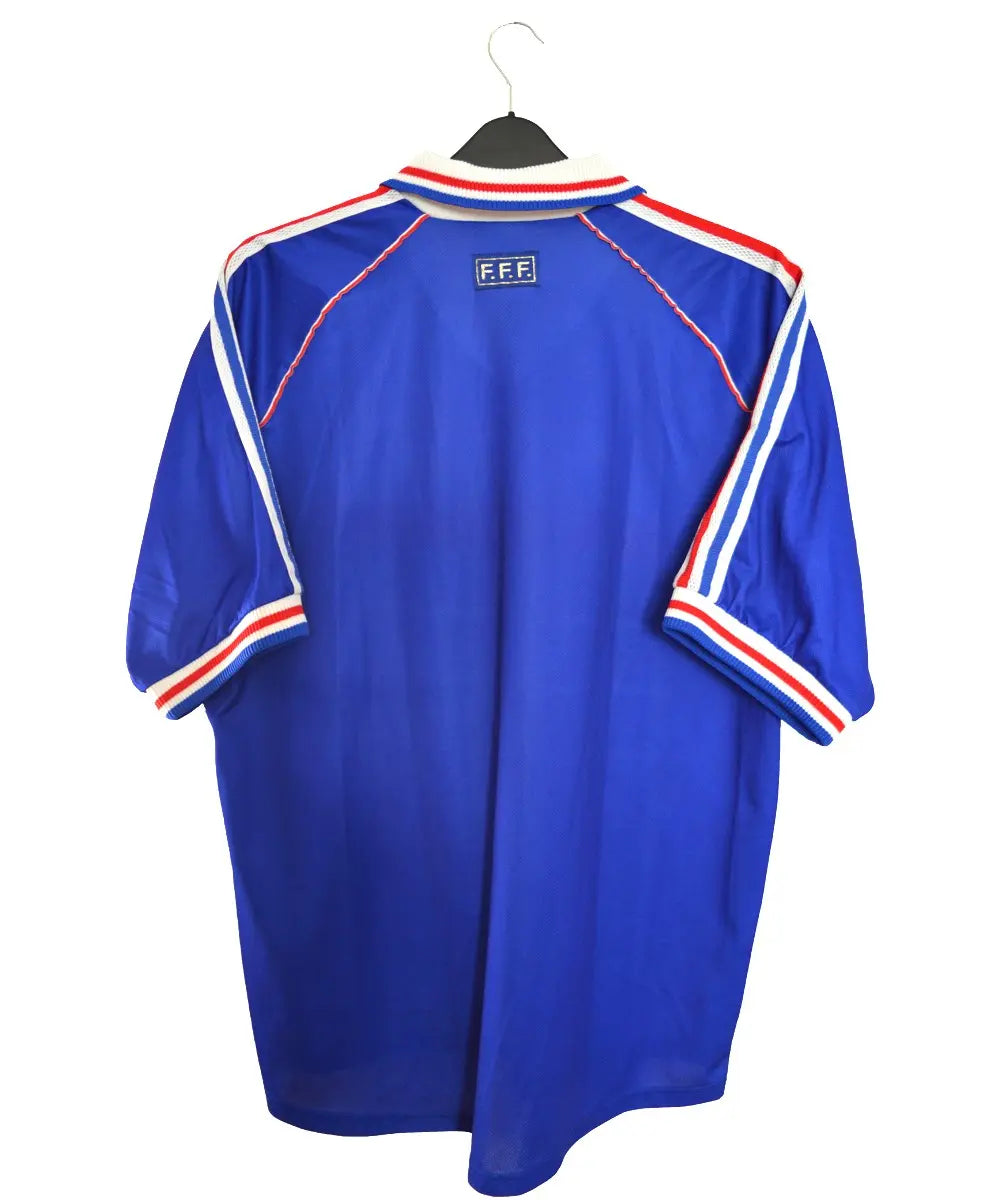 Maillot de foot retro/vintage authentique domicile de dos de l'équipe de france 1998. De couleur bleu et rouge, on peut retrouver l'équipementier adidas ainsi qu'une signature de fabien barthez sur le maillot.